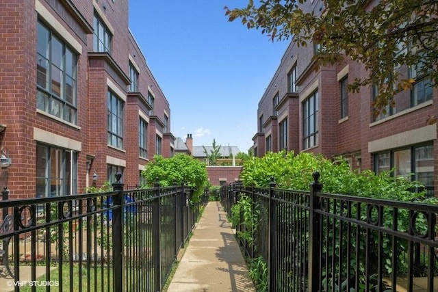view of property's community featuring fence and a residential view