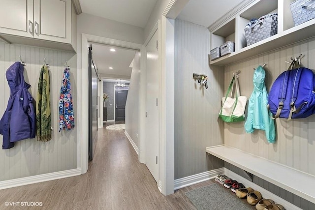 mudroom with baseboards and wood finished floors