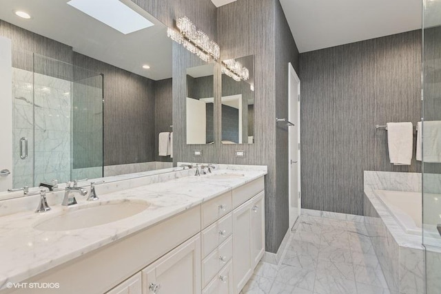 bathroom with double vanity, a relaxing tiled tub, a sink, and marble finish floor