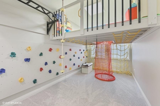 playroom featuring baseboards and carpet