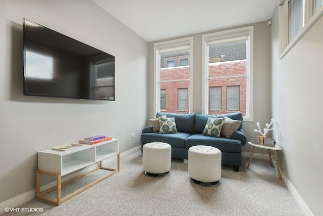 living area with baseboards, carpet floors, and a wealth of natural light
