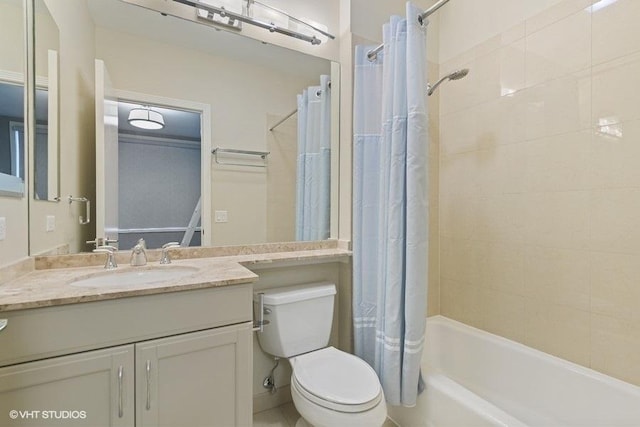 bathroom featuring toilet, shower / bath combination with curtain, and vanity