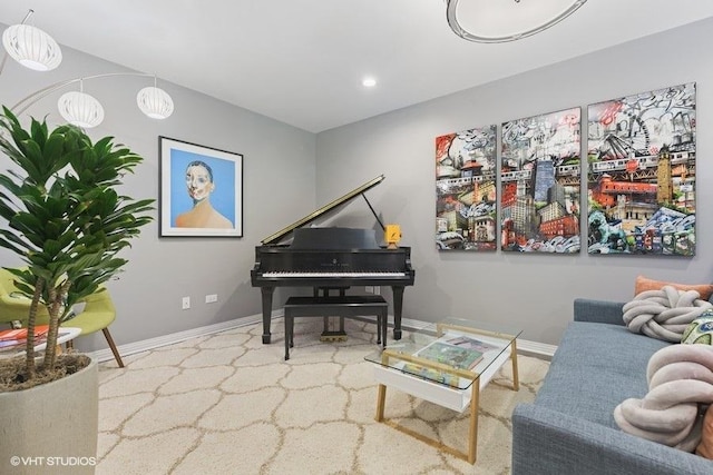 living area featuring baseboards and recessed lighting