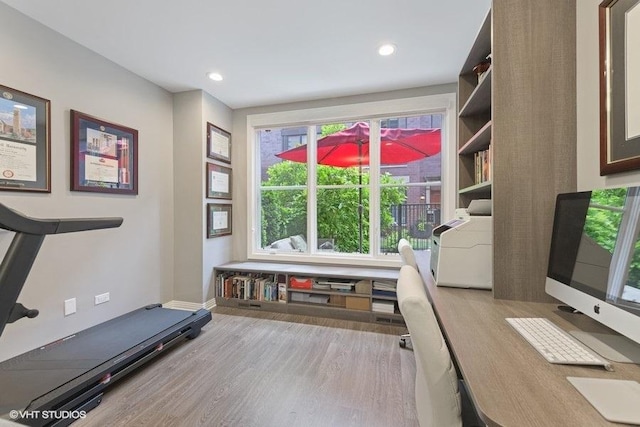 exercise area featuring baseboards, recessed lighting, and wood finished floors
