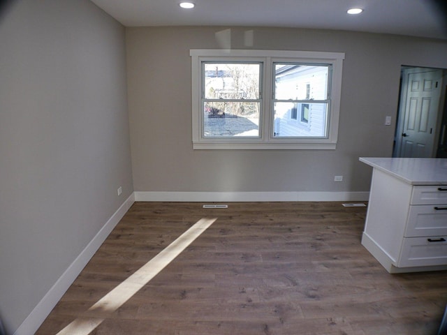 unfurnished dining area featuring wood finished floors, recessed lighting, visible vents, and baseboards