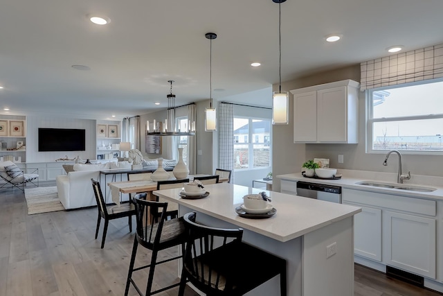 800 Cloverleaf Dr, Marengo, IL 60152 - kitchen featuring a sink, a center island, white cabinetry, light countertops, and dishwasher