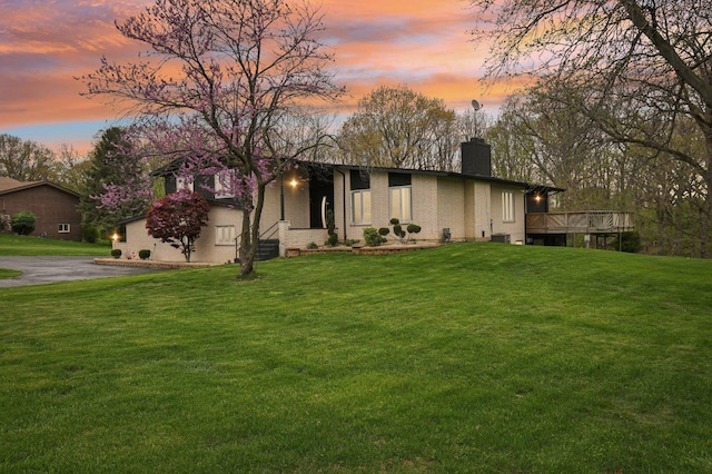 11702 Center Dr, Lemont, IL 60439 - mid-century home featuring a yard, a chimney, and a wooden deck