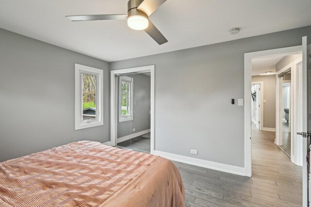 11702 Center Dr, Lemont, IL 60439 - bedroom featuring a closet, wood finished floors, baseboards, and ceiling fan