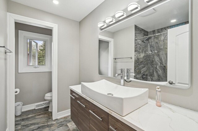 11702 Center Dr, Lemont, IL 60439 - full bathroom featuring recessed lighting, toilet, baseboards, walk in shower, and vanity