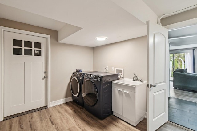 11702 Center Dr, Lemont, IL 60439 - washroom with a sink, laundry area, washing machine and clothes dryer, light wood finished floors, and baseboards