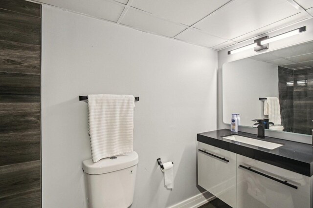 11702 Center Dr, Lemont, IL 60439 - bathroom with a paneled ceiling, baseboards, vanity, and toilet