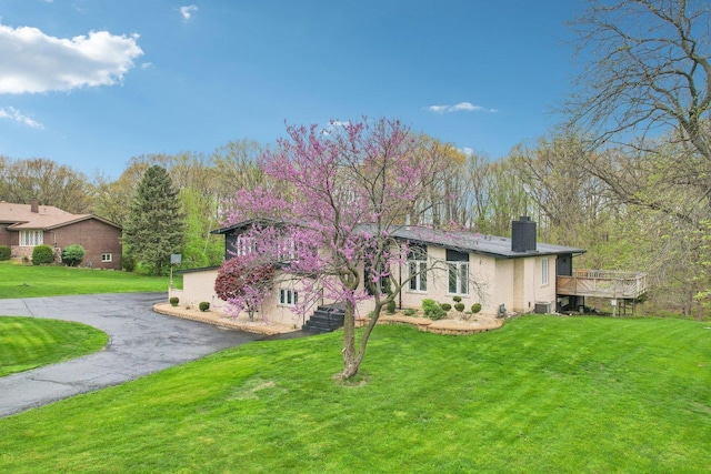 11702 Center Dr, Lemont, IL 60439 - view of front of house with a chimney, a front yard, and a deck