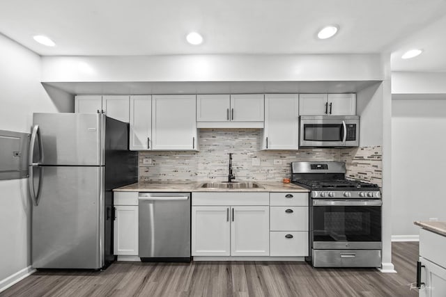 7808 Woodward Ave Unit 41-4G, Woodridge, IL 60517 - kitchen featuring appliances with stainless steel finishes, a sink, wood finished floors, and white cabinets