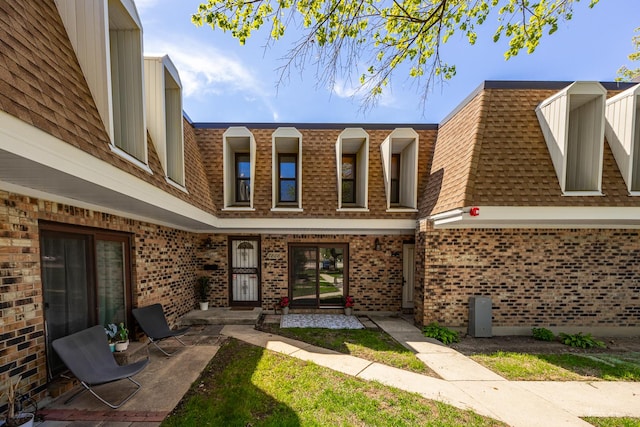 7808 Woodward Ave Unit 41-4G, Woodridge, IL 60517 - exterior space with a shingled roof, brick siding, and mansard roof