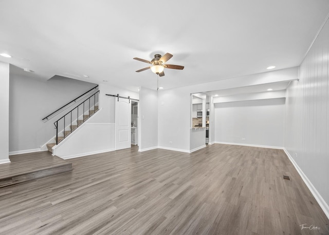 7808 Woodward Ave Unit 41-4G, Woodridge, IL 60517 - unfurnished living room featuring a barn door, ceiling fan, stairs, wood finished floors, and recessed lighting