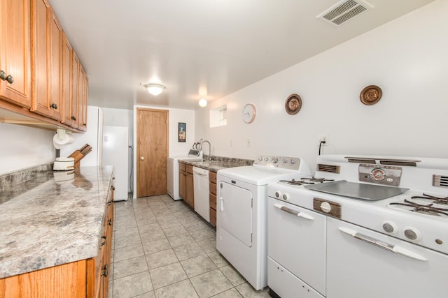 7313 W Howard Ave, Chicago, IL 60631 - kitchen with light tile patterned flooring, visible vents, washer / dryer, and white appliances