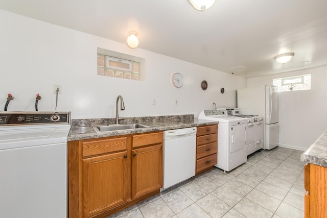 7313 W Howard Ave, Chicago, IL 60631 - kitchen with a sink, light tile patterned flooring, white dishwasher, brown cabinetry, and washer and dryer