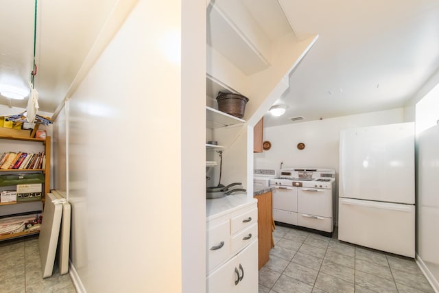 7313 W Howard Ave, Chicago, IL 60631 - kitchen featuring light tile patterned flooring, white appliances, open shelves, washer / clothes dryer, and white cabinets