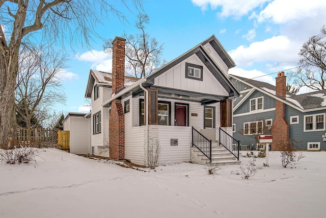 view of front facade with fence and board and batten siding