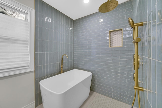 full bathroom with tile patterned floors, a freestanding bath, tiled shower, and tile walls