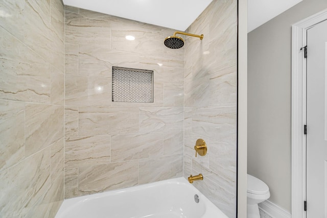 bathroom with baseboards, toilet, and  shower combination