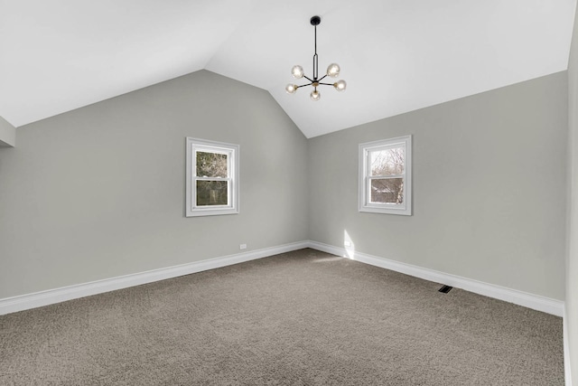 bonus room featuring carpet flooring, visible vents, baseboards, vaulted ceiling, and a notable chandelier
