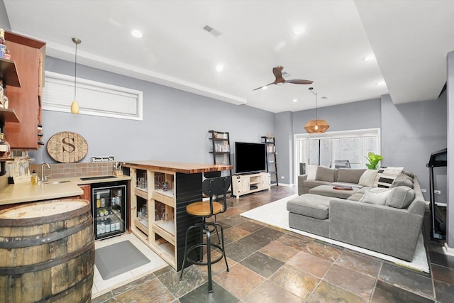 1730 W Diversey Pkwy Unit 1E, Chicago, IL 60614 - living room with beverage cooler, a ceiling fan, stone tile floors, and recessed lighting