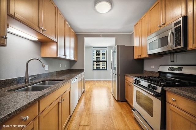201 N Westshore Dr Unit 1207, Chicago, IL 60601 - kitchen featuring baseboards, light wood-type flooring, a sink, dark stone countertops, and appliances with stainless steel finishes