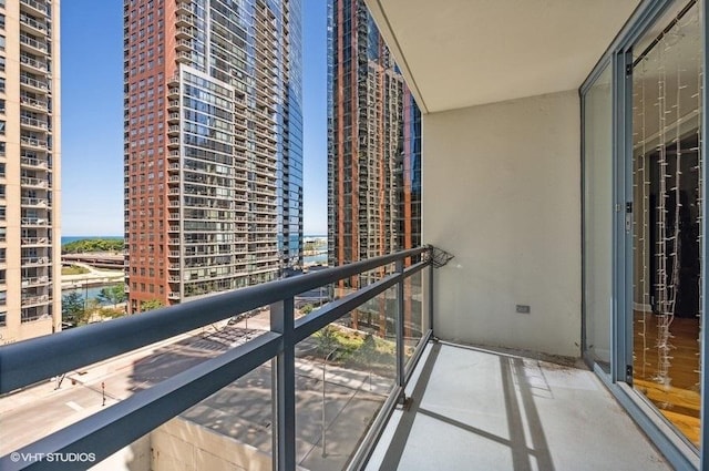 balcony featuring a view of city and a water view