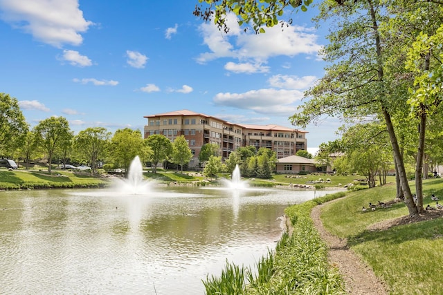 surrounding community featuring a yard and a water view