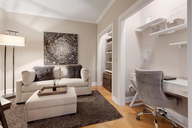office area with ornamental molding, light wood finished floors, and baseboards