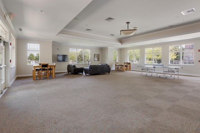 living area featuring visible vents, crown molding, and a tray ceiling