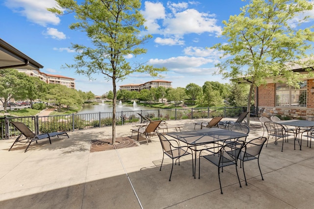 view of patio / terrace with fence and a water view