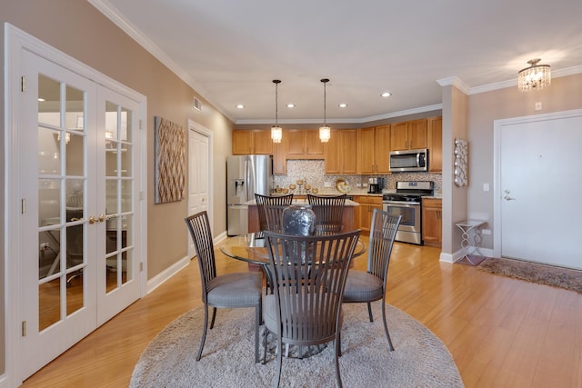 dining space with recessed lighting, light wood-style floors, french doors, and crown molding
