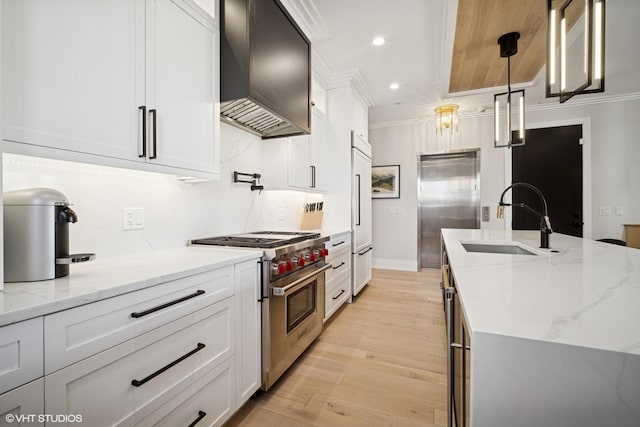 kitchen with crown molding, a sink, recessed lighting, wall chimney exhaust hood, and high quality appliances
