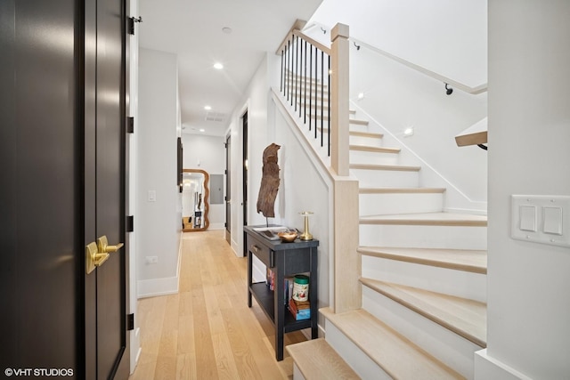 stairway with baseboards, recessed lighting, and wood finished floors