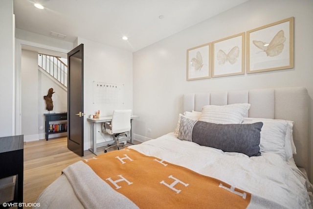 bedroom with light wood-type flooring, recessed lighting, and baseboards