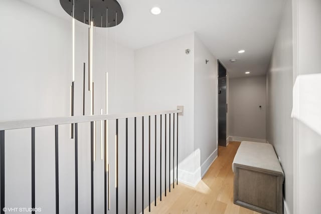 corridor with recessed lighting, wood finished floors, and baseboards