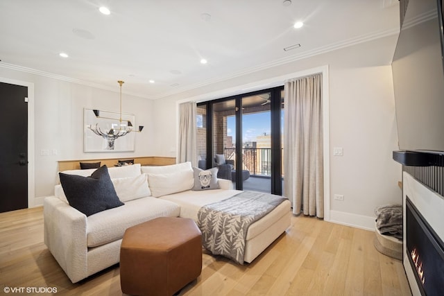 living area with crown molding, light wood finished floors, recessed lighting, and a notable chandelier