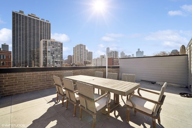 view of patio featuring a view of city and outdoor dining space