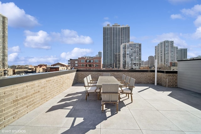 view of patio / terrace with outdoor dining space and a city view