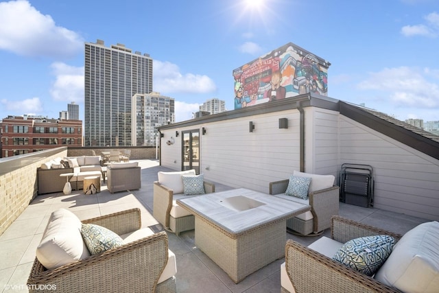 view of patio / terrace with a view of city, outdoor lounge area, and french doors