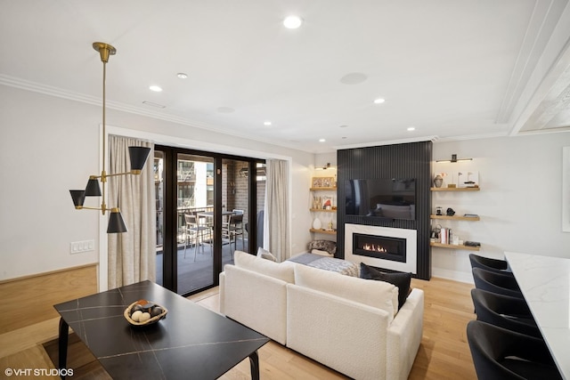 living area with a fireplace, light wood-type flooring, crown molding, and recessed lighting
