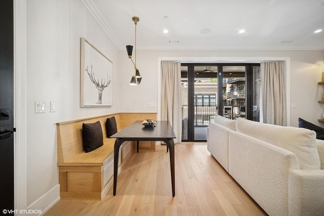 living room with ornamental molding, recessed lighting, and light wood-type flooring