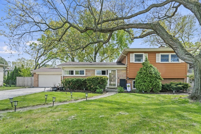 tri-level home with brick siding and driveway