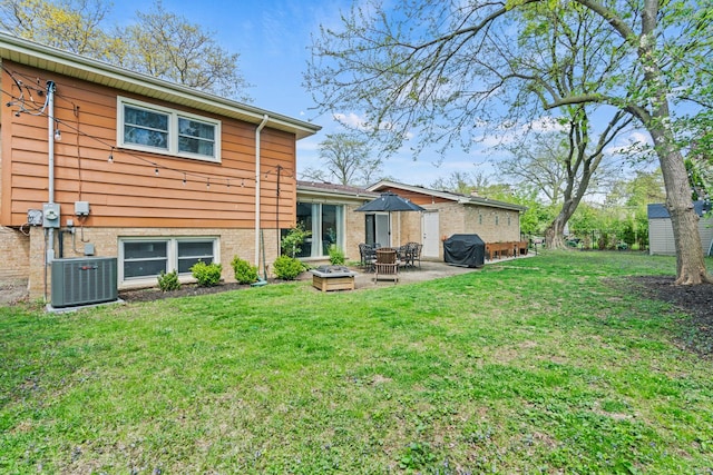 back of house with central AC, a patio, and a yard