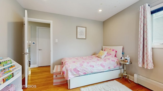 bedroom with baseboard heating, recessed lighting, and light wood-style flooring