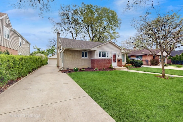 view of front facade featuring a front lawn, roof with shingles, a chimney, brick siding, and a detached garage