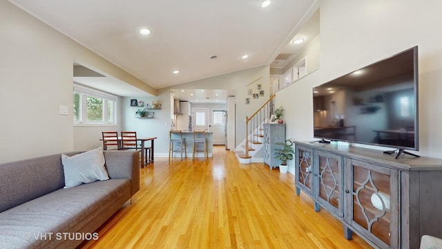 living area featuring recessed lighting, stairway, lofted ceiling, and light wood finished floors