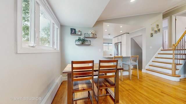 dining room featuring recessed lighting, baseboards, light wood finished floors, and stairs
